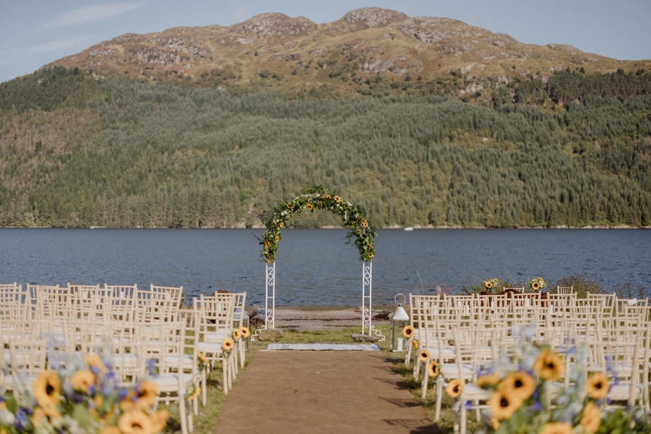 Sunflower-decorated waterside ceremony with Loch Goil in background